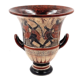 May include: A red and black ceramic vase with two handles and a geometric design. The vase features a scene of two figures in red and black, possibly warriors, with spears and bows.