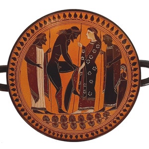 May include: A black-figure Attic kylix, a type of ancient Greek drinking cup, with a red background and black figures. The figures depict a scene with four people, including a man with a beard, a woman with a long dress, and two other figures. The cup is decorated with a black and white geometric pattern around the rim.