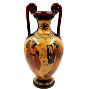 May include: A brown and black ceramic amphora with two handles. The amphora is decorated with a black and white scene of two figures, one playing a lyre and the other holding a staff. The amphora is decorated with a black and white geometric pattern around the neck.