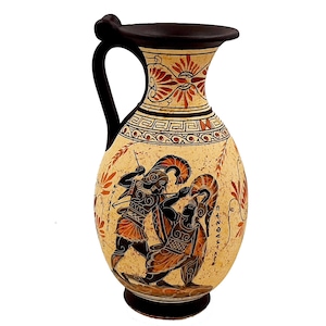 May include: A ceramic Greek amphora vase with a black handle and a beige body. The vase is decorated with a red and black scene of two warriors fighting. The vase has a geometric pattern around the neck and a floral pattern around the base.