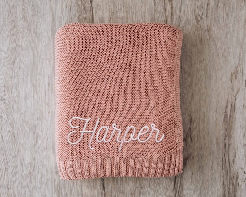 a pink sweater with the word harper written on it