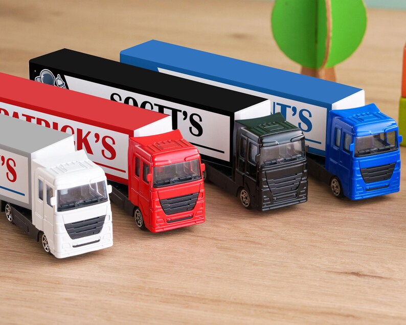 A collection of toy trucks in various colors, including red, white, blue, and black, arranged on a wooden surface.