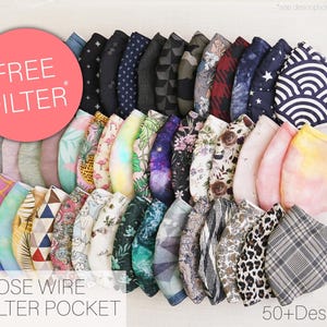 May include: A collection of over 50 fabric face masks featuring diverse patterns including geometric shapes, floral prints, animal motifs, and tie-dye designs. Each mask includes a nose wire and filter pocket. A pink circle displays the text FREE FILTER.
