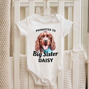a baby bodysuit with a picture of a dog on it