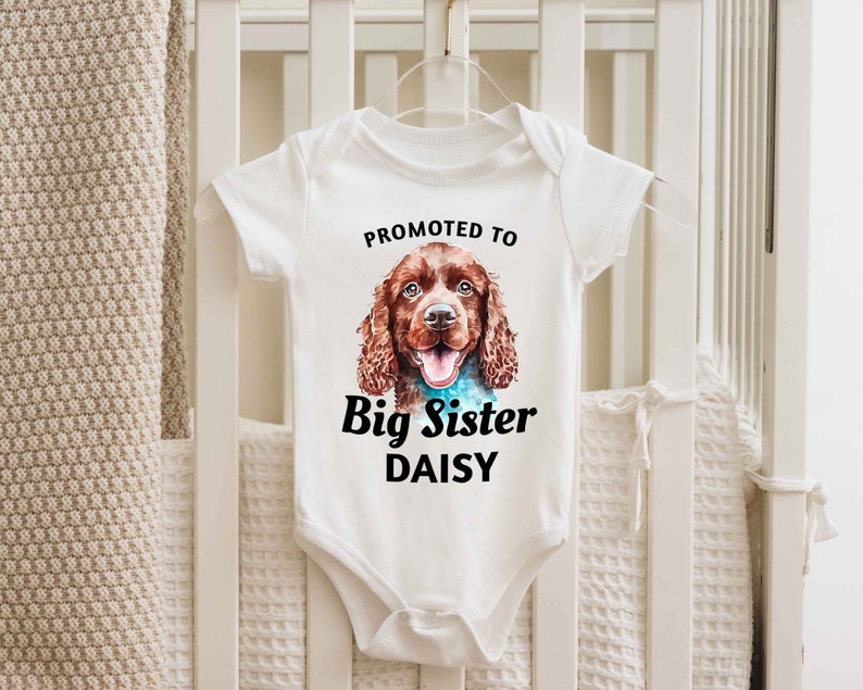 a baby bodysuit with a picture of a dog on it