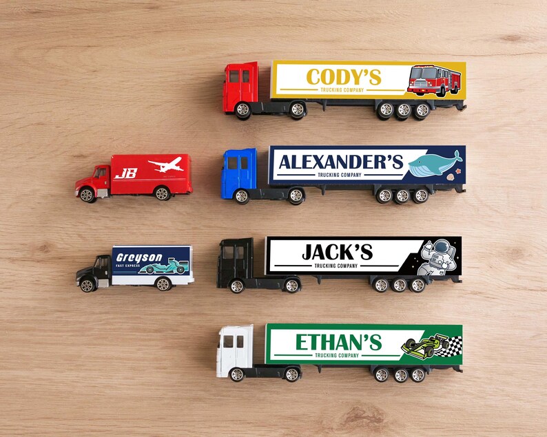 A collection of toy trucks with various company names and logos on them, arranged on a wooden surface.