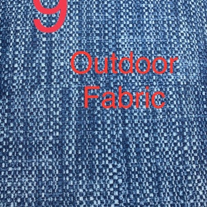 May include: A close-up of a blue fabric with a white pattern. The fabric has the number "9" and the text "Outdoor Fabric" printed on it in red.