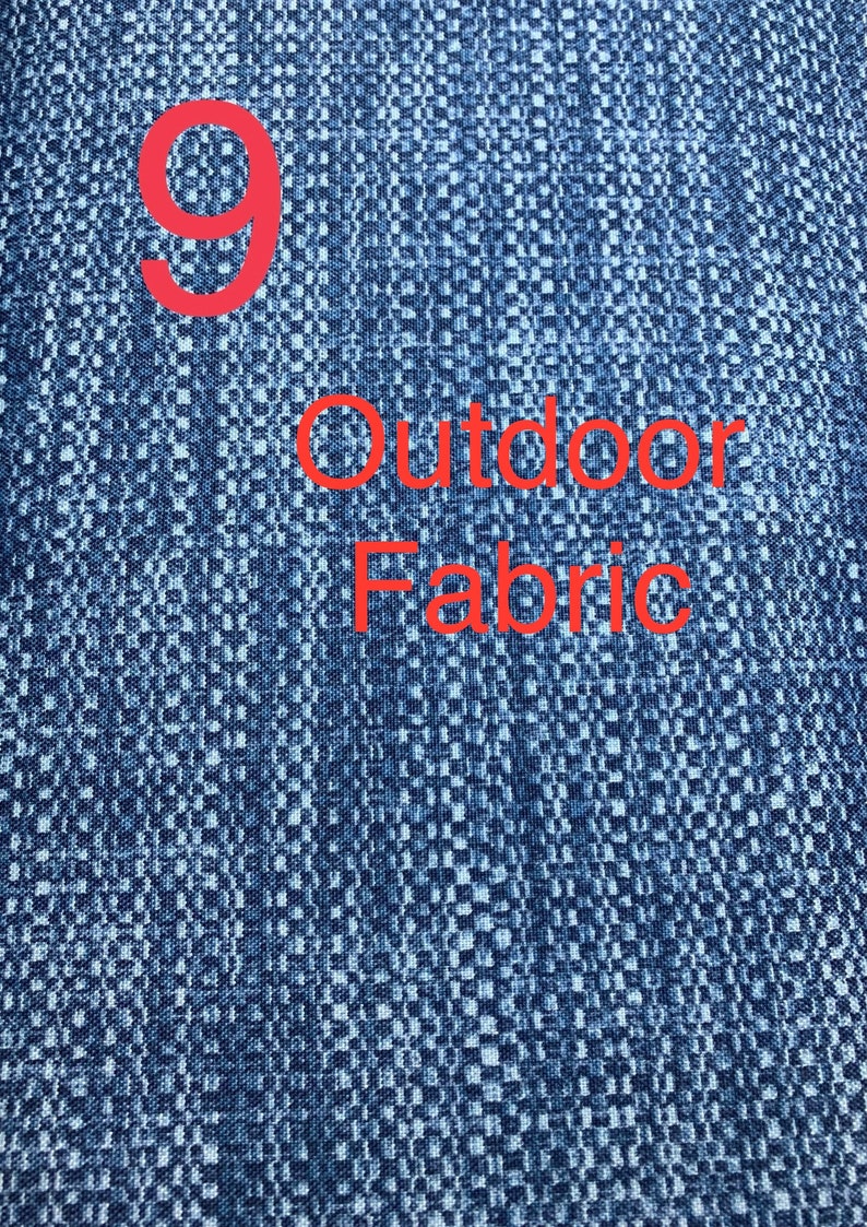 May include: A close-up of a blue fabric with a white pattern. The fabric has the number "9" and the text "Outdoor Fabric" printed on it in red.