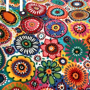May include: Colorful fabric with a repeating pattern of circles and flowers. The circles are filled with dots and the flowers have a central circle with petals around it. The fabric is white with a variety of colors including red, orange, yellow, green, blue, and purple.