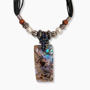 May include: A rectangular pendant necklace with a mother-of-pearl design. The pendant is attached to a black cord necklace with silver-colored beads, wooden beads, and faux pearls. The pendant has iridescent colors of blue, green, and brown.