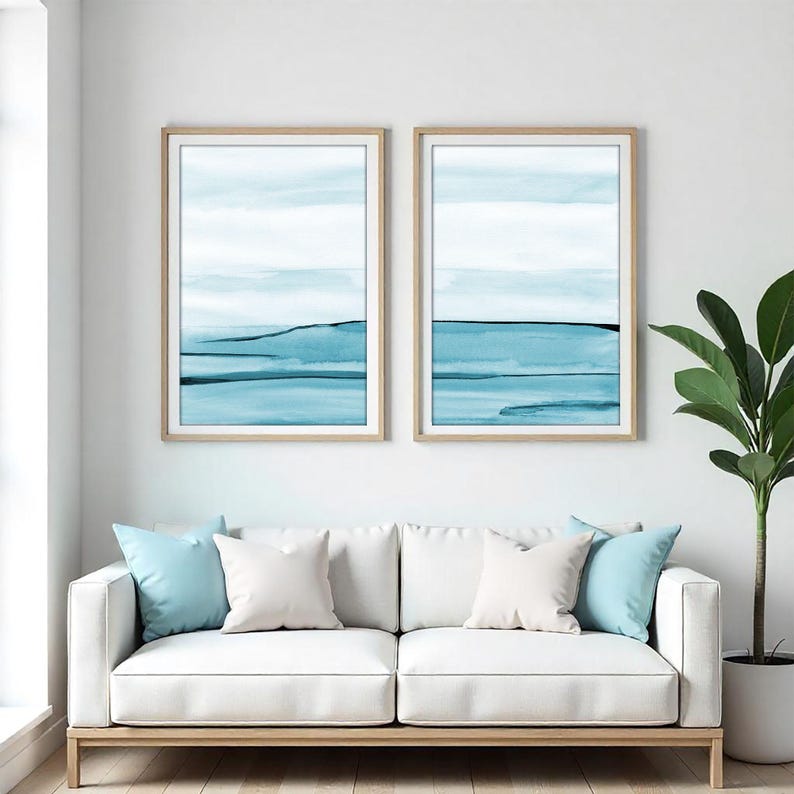 Set of two blue ocean watercolor prints featuring abstract coastal landscapes with soft waves, beach-inspired textures, and calming seaside tones. Coastal wall art set, ocean watercolor print duo, abstract beach wall decor, blue ocean print set of 2, printable coastal artwork for living room, bedroom, beach house, nautical decor, minimalist watercolor ocean art digital download. Designed by CheerfulWatercolors