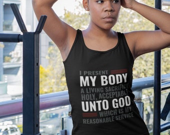 May include: Black tank top with the text "I PRESENT MY BODY A LIVING SACRIFICE HOLY, ACCEPTABLE UNTO GOD WHICH IS MY REASONABLE SERVICE" in white. The person is wearing burgundy leggings. The background includes gym equipment.
