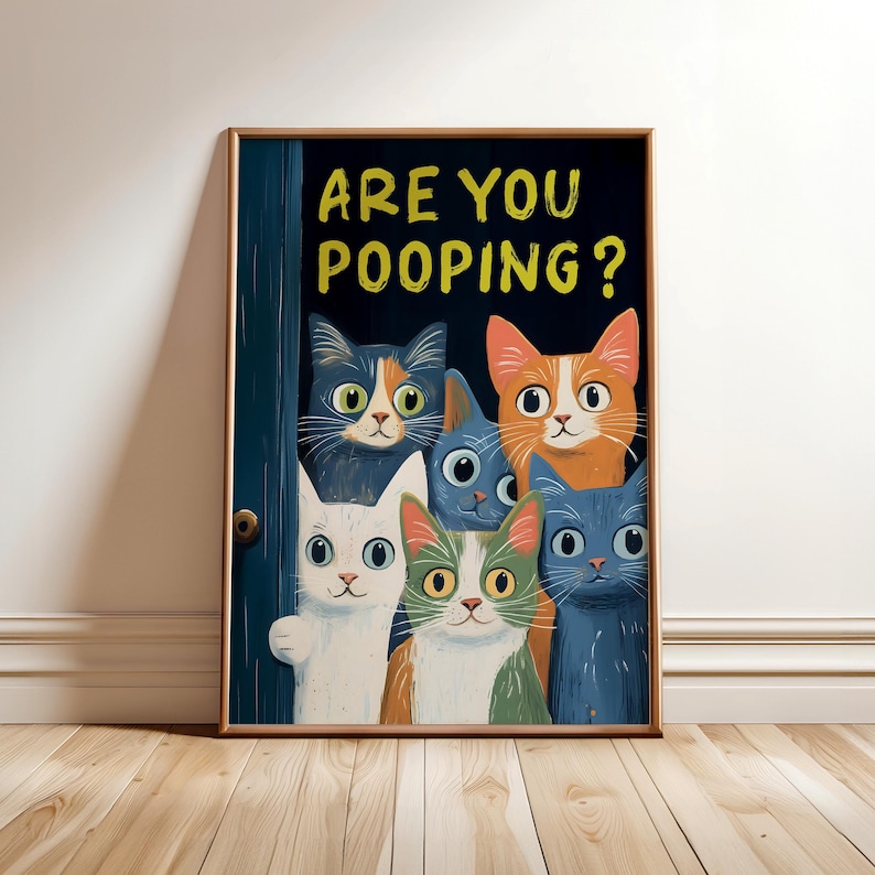 May include: A framed print with a humorous illustration of six cats peeking through a door. The text "ARE YOU POOPING?" is written in yellow letters on a dark blue background.