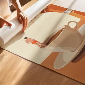 May include: A large poster print featuring a surreal illustration of a person wearing an orange towel standing on the rim of a giant coffee cup and saucer. The artwork uses a warm color palette of cream, brown, and orange tones.