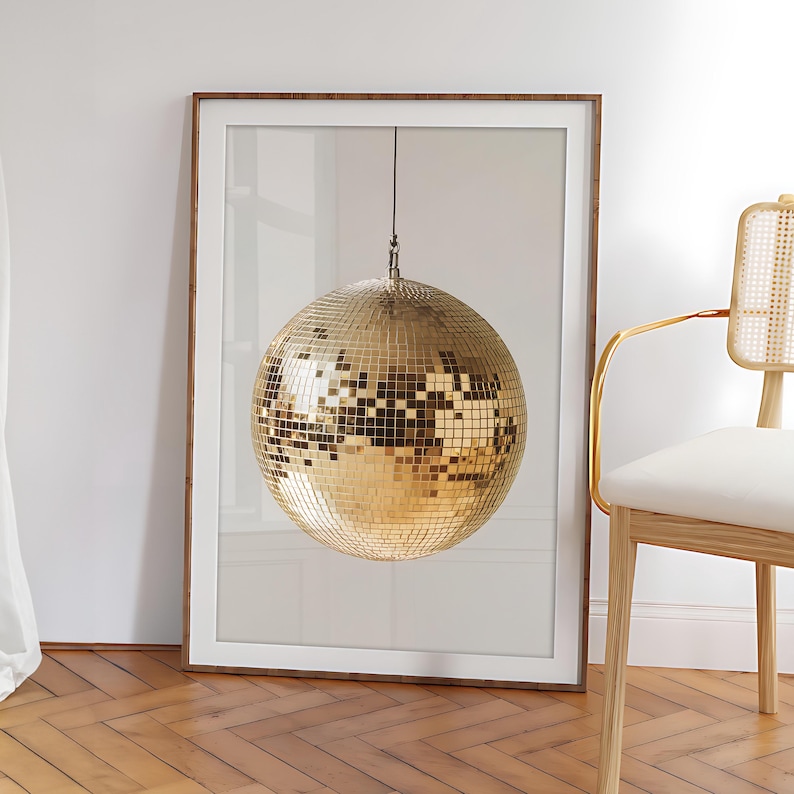 May include: A gold disco ball hanging from the ceiling against a white background.