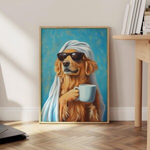 May include: A golden retriever dog wearing sunglasses and a white towel, holding a white coffee mug. The dog is sitting in front of a blue background.