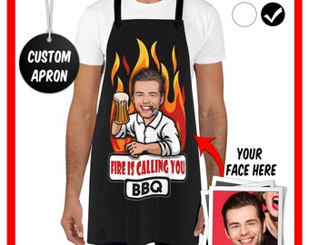 May include: A black apron featuring a cartoon illustration of a person holding a beer mug in front of orange and yellow flames. The text reads "FIRE IS CALLING YOU" and "BBQ" in white and red lettering. A small inset shows a photo of a face.