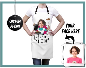 May include: White apron with black straps featuring a cartoon graphic of a person grilling, with the text "BBQ TIME." A tag reads "CUSTOM APRON." The words "YOUR FACE HERE" are next to a photo of a woman.