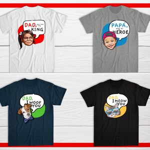 May include: Four t-shirts with graphic designs. The top left shirt is white with a child's face and the text "DAD, you are my KING". The top right shirt is gray with a child's face and the text "PAPA, eres mi HEROE". The bottom left shirt is navy blue with a dog's face and the text "DAD, I woof YOU". The bottom right shirt is black with a cat's face and the text "DAD, I meow YOU".