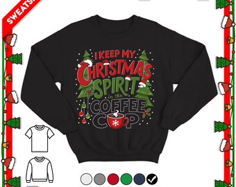 May include: A black long-sleeve sweatshirt featuring a graphic print with two green Christmas trees, red ornaments, and a red coffee cup. The text reads I KEEP MY CHRISTMAS SPIRIT in the COFFEE CUP in red, green, and white lettering.