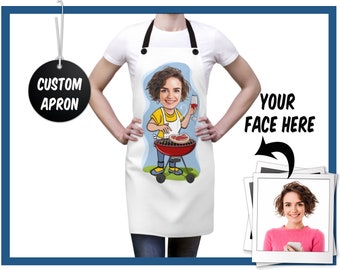 May include: White custom apron with a cartoon illustration of a person grilling. The illustration shows a person holding a glass of wine and grilling a steak on a red grill. The apron has black straps and the text "CUSTOM APRON".