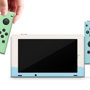 May include: A light blue and white Nintendo Switch console with a green Joy-Con controller. The console has a screen displaying a black background. The Joy-Con controller has a green background with black buttons.