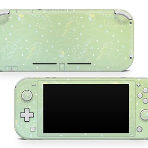 May include: A green and white Nintendo Switch Lite console with a dinosaur pattern. The console has a black screen and white buttons.