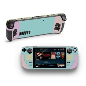 Puede incluir: Una consola de juegos portátil de color verde azulado y rosa con una pantalla que muestra un menú de juegos. La consola tiene un botón negro en el lado izquierdo y un botón negro en el lado derecho.