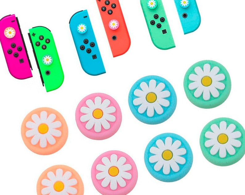 May include: A set of ten colorful daisy-shaped thumb grips for video game controllers. The grips are in pink, blue, green, and light blue colors with white daisy designs.