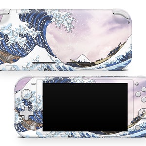 May include: A white Nintendo Switch Lite console with a custom skin featuring a Japanese-style wave design in shades of blue and white. The background is a soft pink with a faint white pattern. The design is reminiscent of the famous Great Wave off Kanagawa woodblock print.