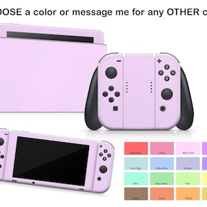 Puede incluir: Una consola Nintendo Switch de color rosa claro con una pantalla negra y mandos Joy-Con negros. La consola se muestra con una selección de cuadrados de colores, incluyendo frambuesa, rosa, rosa bebé, lila, huevo de pato, azul bebé, humo, lavanda, menta, verde mar, guisante, limón, sepia, coral, melocotón y albaricoque.