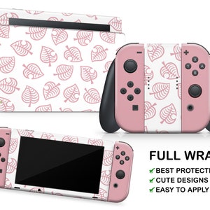 May include: Pink Nintendo Switch console with a white and pink Animal Crossing: New Horizons themed skin. The skin features a repeating pattern of pink leaf designs. The text "FULL WRAP" is visible in the image. The text "BEST PROTECTION", "CUTE DESIGNS", and "EASY TO APPLY" are also visible in the image.
