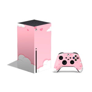 May include: Pink and white Xbox Series X console and controller skin with a cloud and heart design.