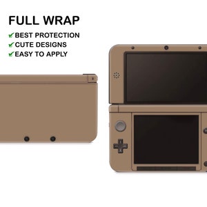 May include: A tan Nintendo 3DS XL console with a full wrap skin. The console is closed and the top screen is visible. The bottom screen is also visible and shows the control buttons. The console is on a white background. FULL WRAP, BEST PROTECTION, CUTE DESIGNS, EASY TO APPLY.