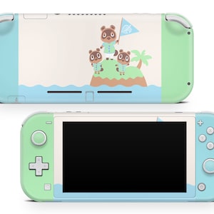 Puede incluir: Una consola Nintendo Switch Lite verde y azul con una piel personalizada que presenta personajes de la serie de videojuegos Animal Crossing. La piel representa a tres personajes animales de pie en una pequeña isla con una palmera y una bandera.