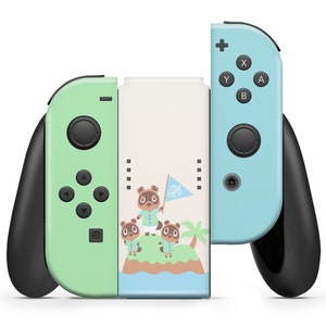 May include: A green and blue Nintendo Switch console with a custom skin featuring Tom Nook and other Animal Crossing characters. The console is in a closed position with the joy-cons attached.