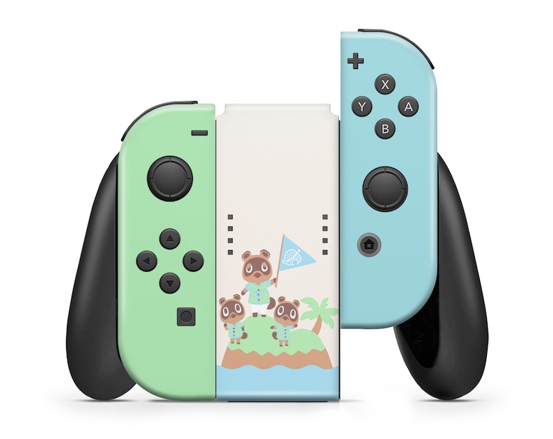 May include: A green and blue Nintendo Switch console with a custom skin featuring Tom Nook and other Animal Crossing characters. The console is in a closed position with the joy-cons attached.