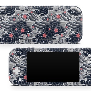 May include: A white Nintendo Switch Lite console with a custom skin featuring a black and gray Japanese wave pattern with pink cherry blossoms.