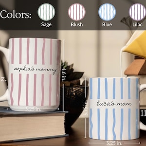 May include: Two white ceramic mugs with vertical stripes in blush and blue. The larger 15 oz. mug is 4.6 inches tall and 3.25 inches wide, labeled 'sophia's mommy'. The 11 oz. mug is 3.75 inches tall and 3.25 inches wide, labeled 'luca's mom'.