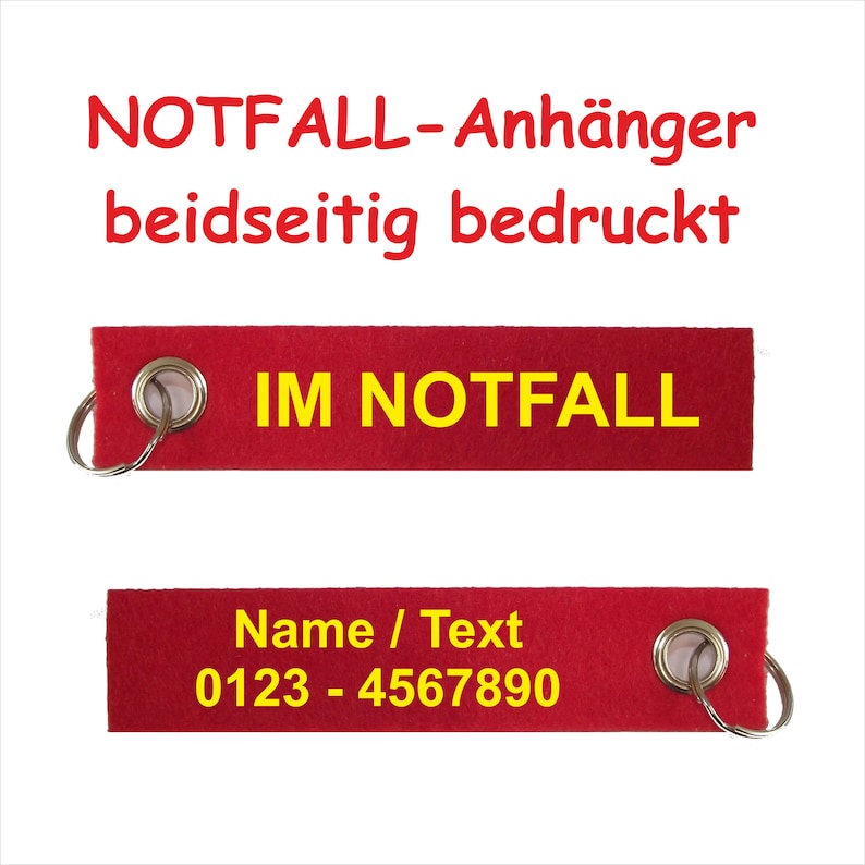 May include: Red fabric keychain with a metal ring. The keychain has yellow text that reads "IM NOTFALL" and "Name / Text 0123 - 4567890".