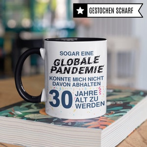 May include: White ceramic mug with a black rim and handle. The mug has a black and blue graphic that says "Even a global pandemic couldn't stop me from turning 30".