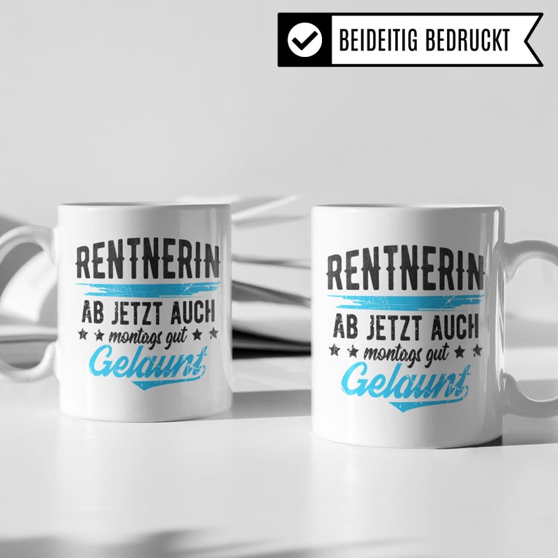 May include: Two white ceramic mugs with black text that reads "RENTNERIN AB JETZT AUCH montags gut Gelaunt". The text is in a distressed font style. The mugs are on a white surface.