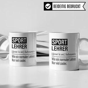 May include: Two white ceramic mugs with black text that reads "SPORT LEHRER [sport le:re] Substantiv Wie ein normaler Lehrer. Nur viel cooler."