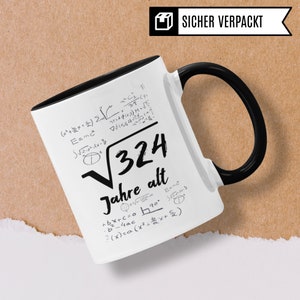 May include: White ceramic mug with a black handle. The mug has a black rim and features a black and white design of mathematical equations and the text "&radic;324 Jahre alt".