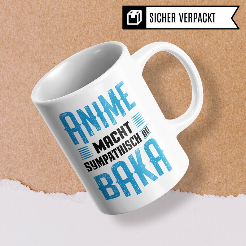 May include: White ceramic mug with a blue and black design. The text on the mug reads "Anime Macht Sympathisch Du Baka".