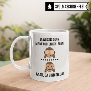 May include: White ceramic mug with a black and brown monkey graphic and the text "JA WO SIND DENN MEINE DOOFEN KOLLEGEN ......... AAAH, DA SIND SIE JA!"