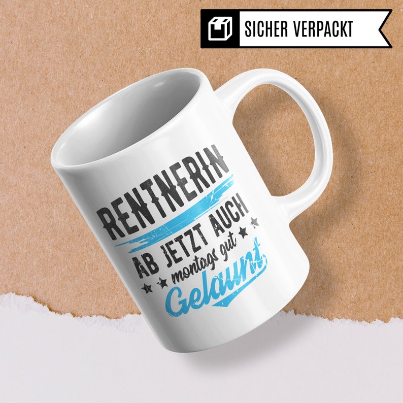 May include: White ceramic mug with a blue and black graphic that says "Rentnerin ab jetzt auch montags gut gelaunt".