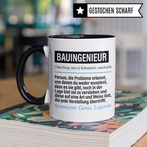May include: White ceramic mug with a black handle and black rim. The mug has a black and white design with the text "BAUINGENIEUR ['bao?inze, nio:e] Substantiv, maskulin Person, die Probleme erkennt, von denen du weder wusstest, dass es sie gibt, noch in der Lage bist sie zu verstehen und diese auf eine Art und Weise l&ouml;st, die jede Vorstellung &uuml;bertrifft. Synonyme: Genie, Legende"