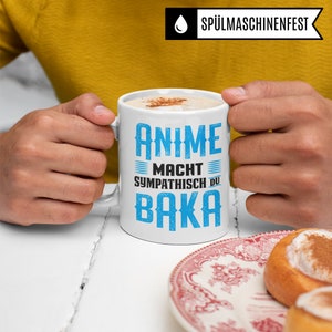 May include: White coffee mug with blue text that reads "Anime Macht Sympathisch Du Baka".