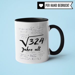 May include: White ceramic mug with a black handle and rim. The mug features a black and white design of mathematical equations and the text "&radic;324 Jahre alt". The text "PER HAND BEDRUCKT" is printed in black on a white heart shape.